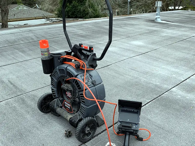 Sewer camera reel with monitor on a concrete drive