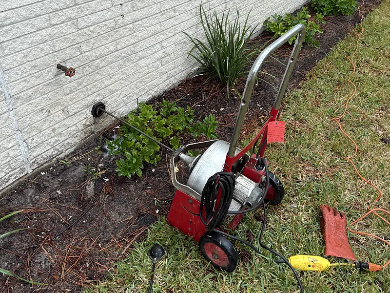 Royal Flush Affordable Plumbing drain machine set up at the cleanout of a Houston home