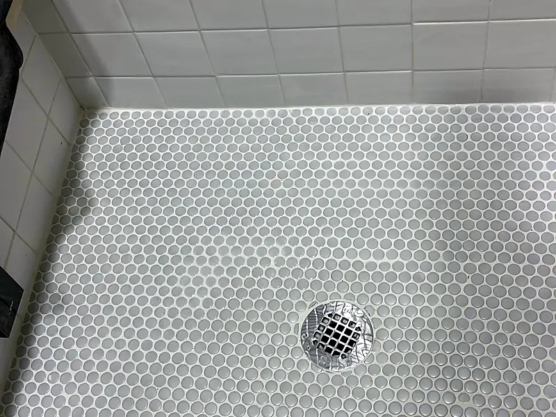 Finished shower floor with penny tile and a new drain