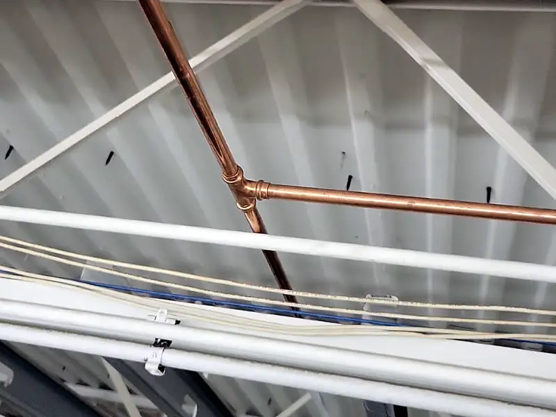 Copper line running across the ceiling of a large store