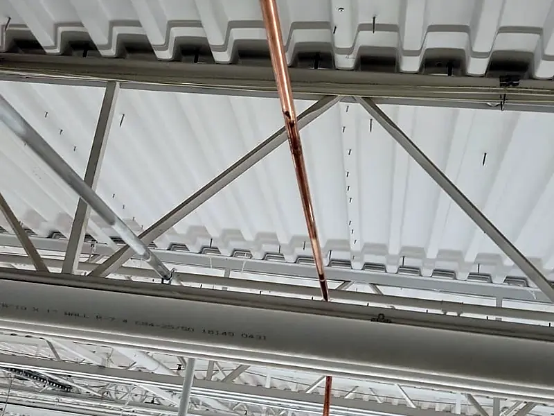 Copper water riser on a column inside a big-box store