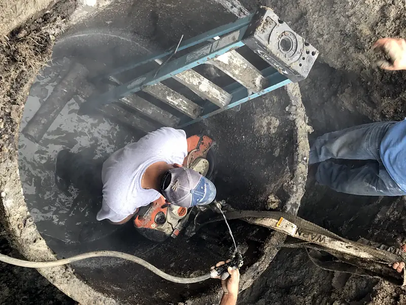 Crew inside a large excavated pit with a ladder