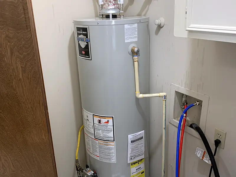 New gas tank water heater installed in a Houston laundry closet by Royal Flush Affordable Plumbing