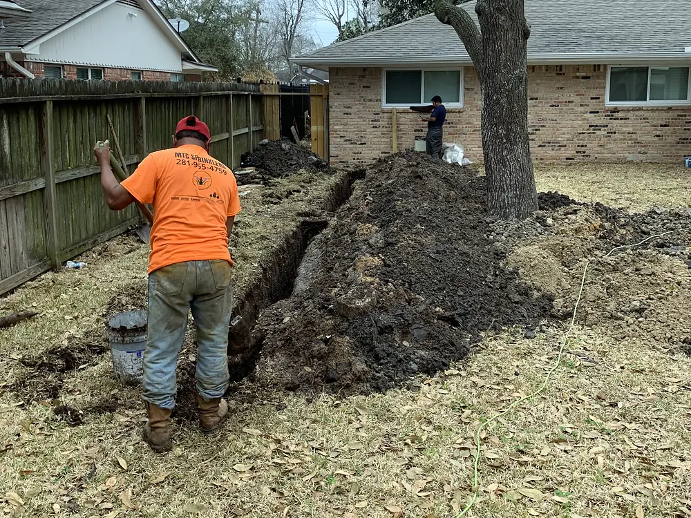 Crew replacing a sewer line in a back yard
