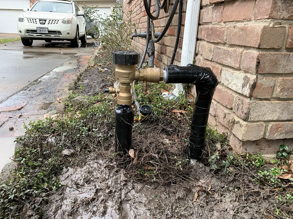 New backflow preventer at a brick home, wrapped and insulated