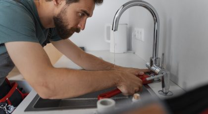 side-view-man-working-as-plumber (1) faucet and sink installation-affordable-plumber-in-houston